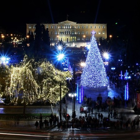 Athens' central Syntagma Square is lit up on Friday, Dec. 11, 2009, during the official inauguration of the Greek capital's Christmas celebrations. Police are on standby in the square for fear vandals might attack the city's main Christmas tree, which was burnt during rioting last year sparked by the fatal police shooting of a teenager. (AP Photo/ Thanassis Stavrakis)